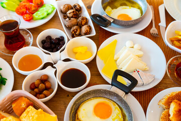 Halal breakfast at the hotel with scrambled eggs, cheese, olives, walnuts, chopped vegetables with parsley and ..a cup of tea.