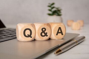 Wooden blocks with Q and A on laptop keyboard