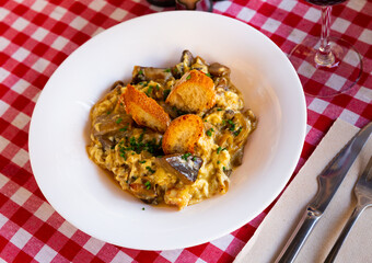 Traditional Spanish omelette with porcini mushrooms, shrimps and caramelized onion garnished with crispy toasts