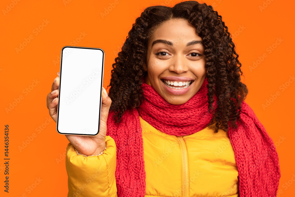 Poster joyful african lady showing phone with empty cellphone screen to camera approving smartphone standin