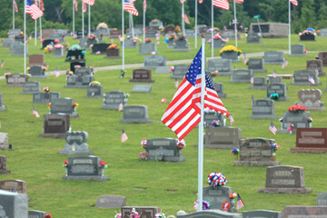 American flags next to cemetery