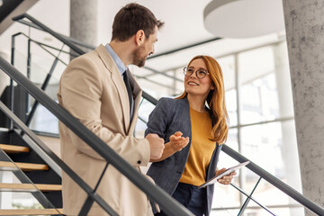 Businesspeople walking on staircase at enterprise and discussing business strategy,