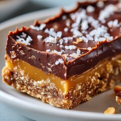 Close-up of a vegan no bake caramel bar made with chocolate oats and dates showcasing natural ingredients and rich texture.
