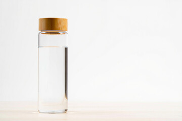 Eco-Friendly Glass Water Bottle with Bamboo Lid on White Background