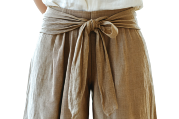 Stylish taupe wide leg pants tied with a beige linen sash soft natural light clean background