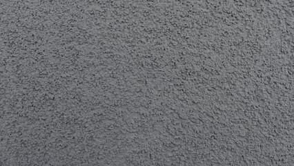 Detailed closeup of a rough gray concrete wall texture, ideal for backgrounds or design projects. For architectural, construction, or graphic design use.