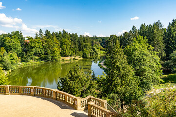 Fototapeta premium A stunning view of a serene lake completely surrounded by trees from a balcony