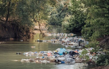 A river with a significant amount of trash and plastic waste