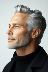 Obraz premium Pure white solid background. Chic men's crew cut haircut - midlife white man with grey hair. A relaxed and charming gentleman with a bright smile. Conceptual art of style for aging men.