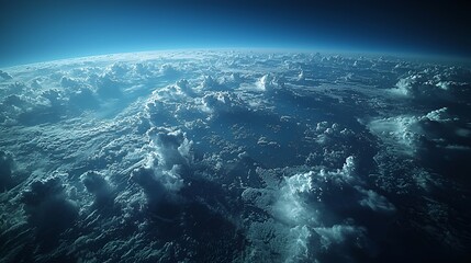 Aerial view of a vast expanse of clouds covering the planet's surface, seen from high above the atmosphere.