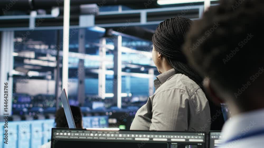 Poster data center admin using laptop to do node tree programming, optimizing resource allocation. woman in