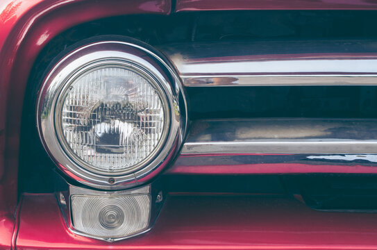 Closeup of old red car headlight.Classic Car Headlight. - Powered by Adobe