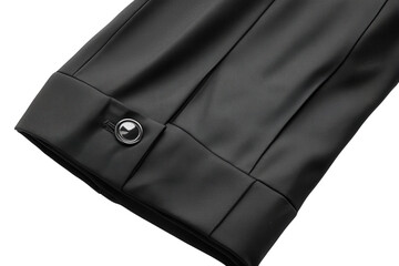 Close up of black jacket sleeve detail showing textured fabric and button Sharp focus neutral
