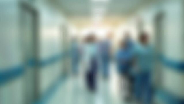 Blurred unidentified patient and medical staff walking in the hospital for background use. Still shot 4K video