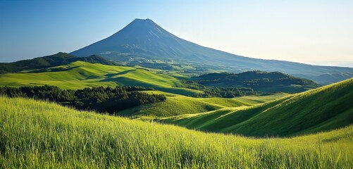 Majestic Mountain Over Rolling Green Hills Under Blue Sky
