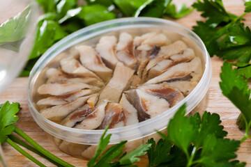 Preserved sardines marinated in oil in plastic container