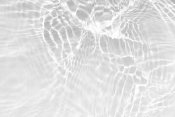 Fototapeta premium Blue water with ripples on the surface. Defocus blurred transparent blue colored clear calm water surface texture with splashes and bubbles. Water waves with shining pattern texture background.