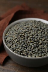 Raw green lentils on wooden table, closeup