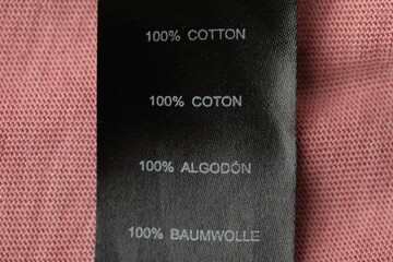 Clothing label with material content on garment, top view