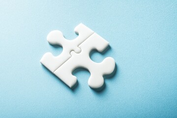 Obraz premium Two white puzzle pieces joined