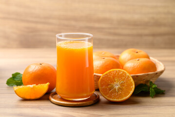 Glass of orange juice and fresh orange fruit on wooden background, Healthy drink