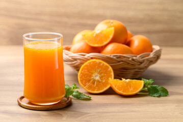 Glass of orange juice and fresh orange fruit on wooden background, Healthy drink