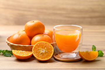 Glass of orange juice and fresh orange fruit on wooden background, Healthy drink
