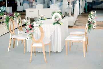 Elegant Wedding Ceremony Setup With White Tables Gold Chairs And Floral Decor
