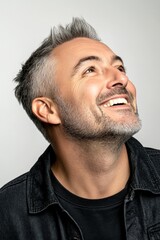 Obraz premium Trendy men's short punk haircut - midlife white man with grey hair. A proud and confident gentleman standing tall. Creative of style for aging men. Pure white solid background.