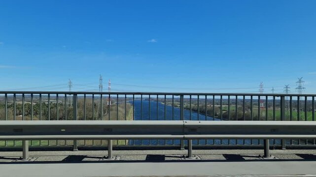 Construction crane rising over Kiel Canal from bridge on Autobahn A7