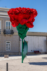 large red carnation flower in plaza
