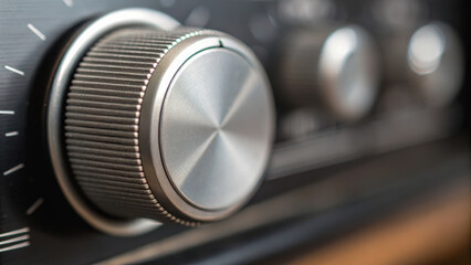 Metal knob control close up in workshop setting with woodwork elements around creating tactile and functional design experience
