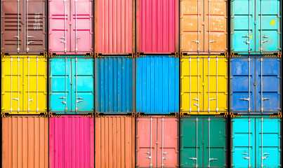 Fototapeta premium Stacked vibrant shipping containers form a colorful pattern, doors shut, ready for global commerce and transport