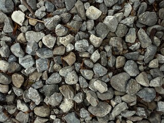 Naklejka premium Detailed Close-up of Natural Grey and Brown Gravel Stones with a Variety of Shapes and Textures, Perfect for Landscaping, Construction, and Garden Pathways