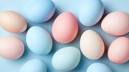 A row of colorful eggs are laid out in a pattern. The eggs are of different colors, including blue, pink, and yellow. The eggs are arranged in a way that creates a sense of harmony and balance