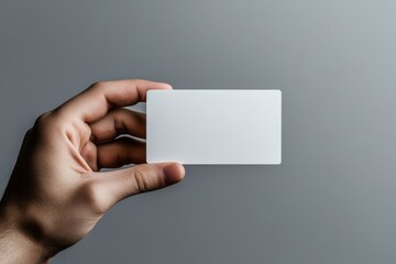 Hand holding blank white business card