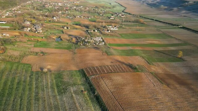 Gentle spring sun warms up the peaceful Romanian countryside. Aerial panoramic perspective