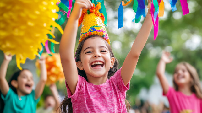 Joyful children celebrating with piñata at mexican birthday party