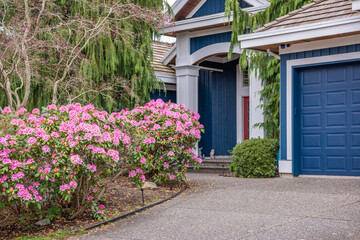 Two story stucco luxury house with nice spring blossom landscape in Vancouver, Canada, North America. Day time on April 2025.