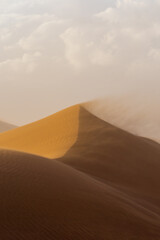 Strong wind blowing the loose sand in the Sahara Desert, Morocco, Africa.
