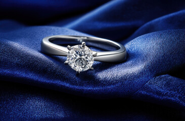 Elegant diamond ring on blue satin fabric, sparkling solitaire gemstone set in silver band, symbolizing love and commitment with luxurious texture and shine