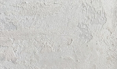 Rough plaster-texture surface with earthy shades creating a natural weathered look.
