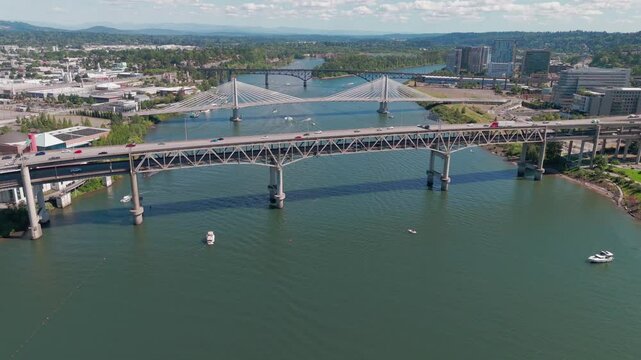 Aerial tracking shot over the Willamette River and the Markham Bridge in downtown Portland Oregon