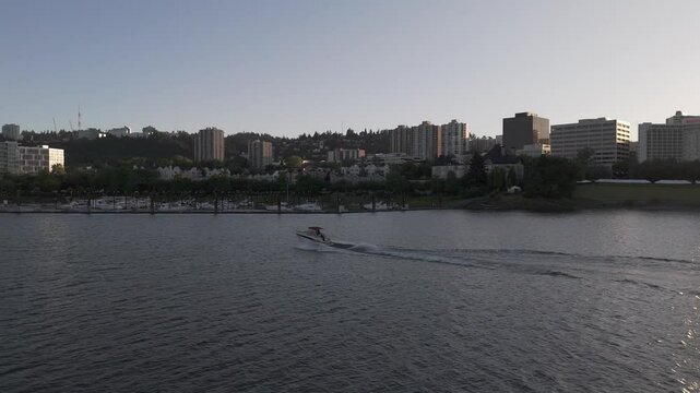 Pan with speedboat on the Willamette river in downtown Portland to reveal the Markham Bridge