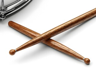 A pair of wooden drumsticks rests on a white background with a blurred drum in the upper left corner.
