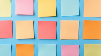 Colorful sticky notes arranged neatly on a blue background in a grid pattern.