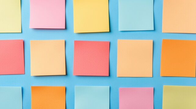 Colorful sticky notes arranged neatly on a blue background in a grid pattern.