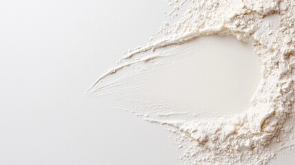 White flour and liquid forming a well on a smooth surface, ready for baking or dough preparation.