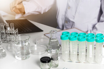 Researchers study data and experiment on chemicals, scientific process, develop safe chemicals.