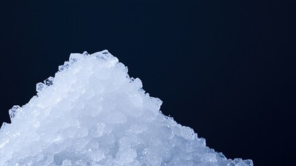 A mound of crushed ice against a dark background, showcasing its crystalline texture and cool appearance.